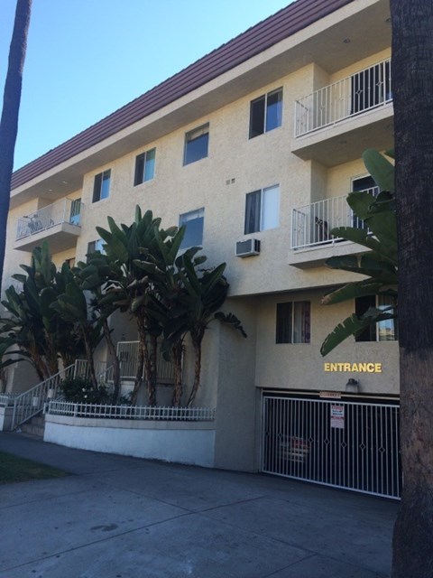 A building with a sign that says "ENTRANCE" on the gate.