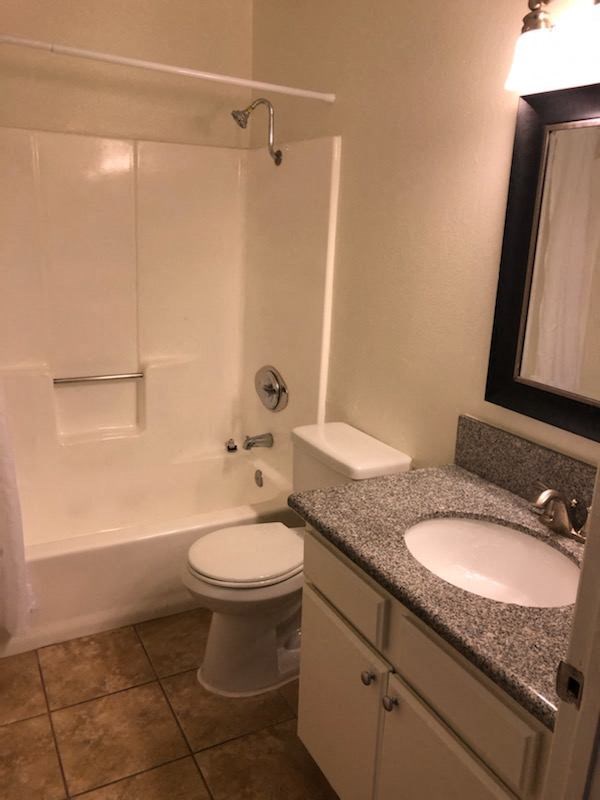 a bathroom with a toilet and a sink and a bath tub