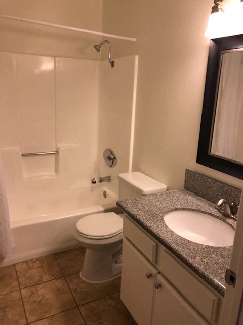 a bathroom with a toilet and a sink and a bath tub