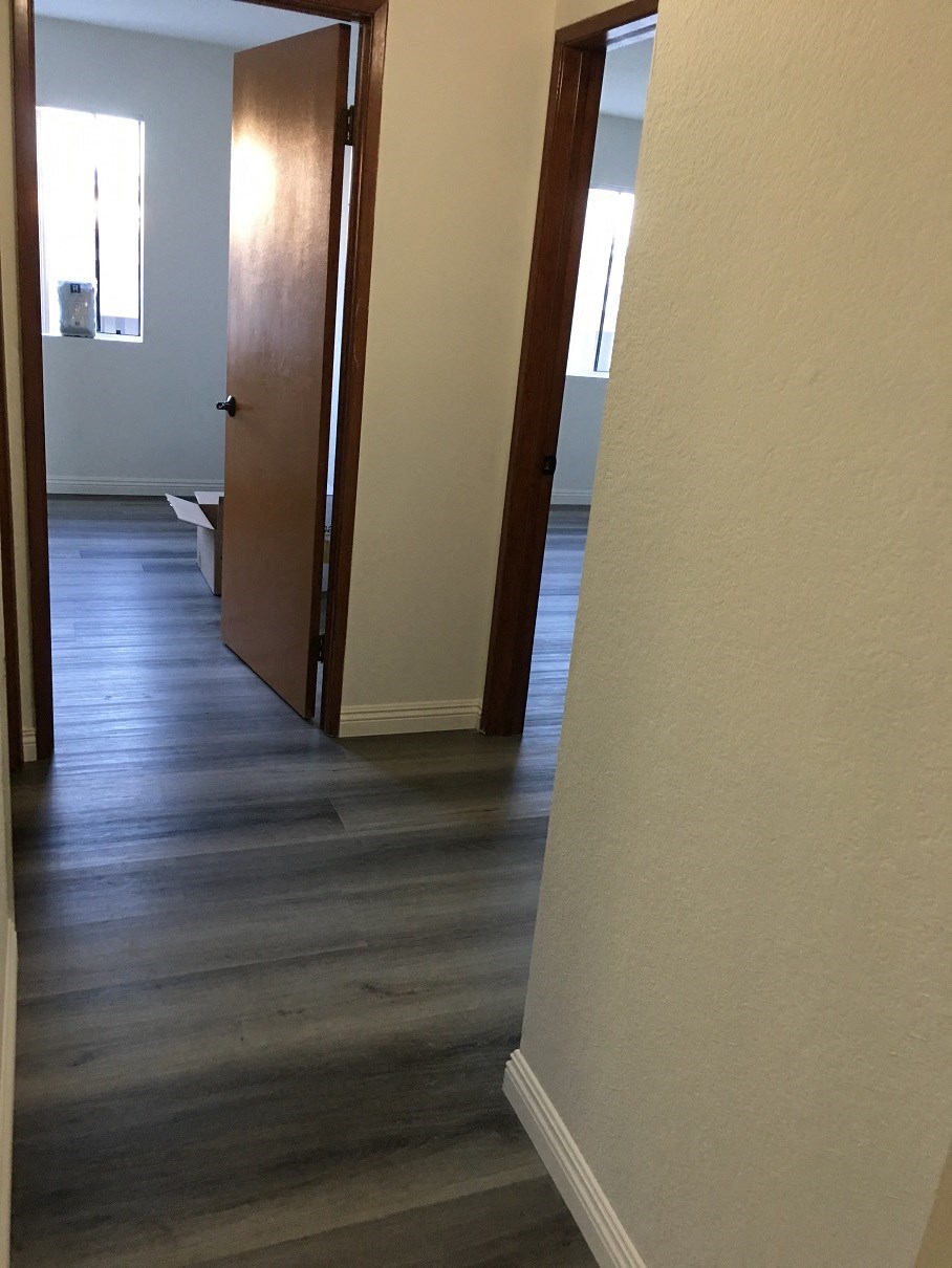 a view of the hallway from the living room into the dining room and the kitchen