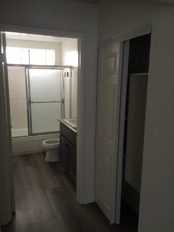 a bathroom with a toilet and a sink and a shower