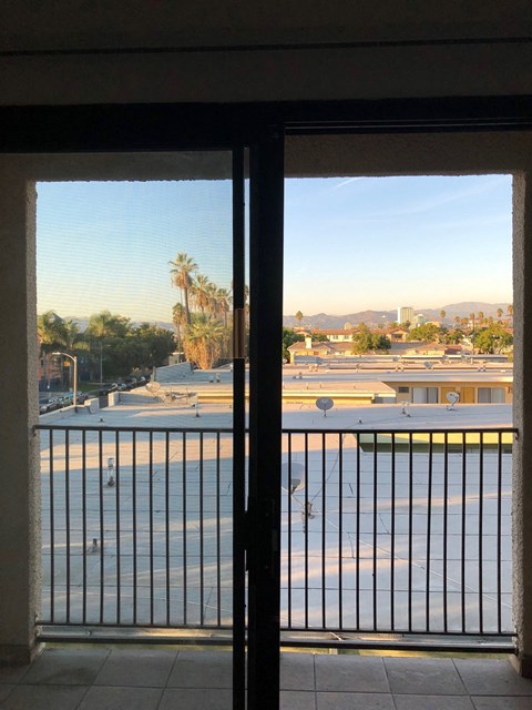 the view from the balcony of a hotel room with a balcony and a balcony door