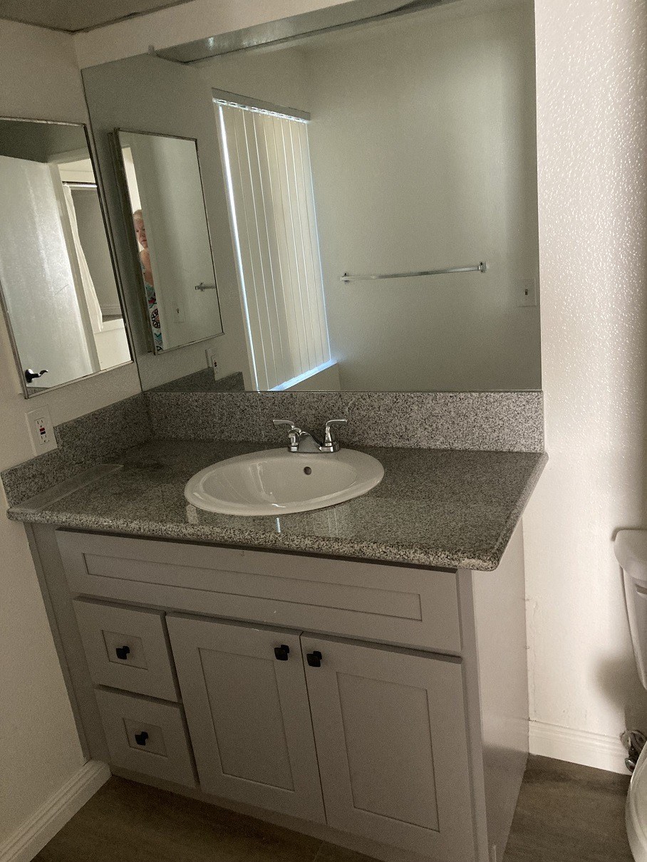 a small bathroom with a sink and a mirror