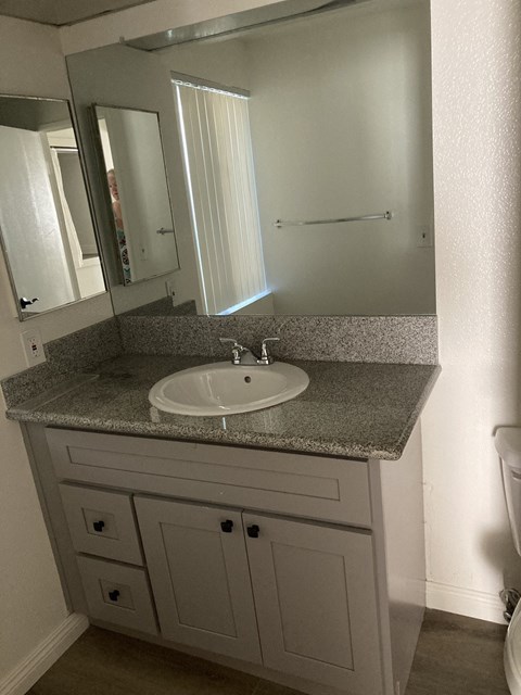 a small bathroom with a sink and a mirror