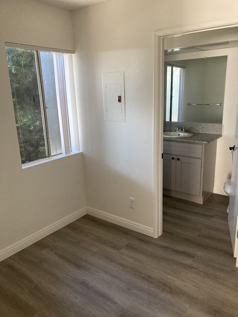 a small bathroom with a window and a sink
