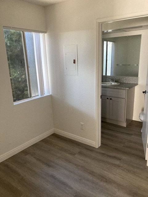 a small bathroom with a window and a sink