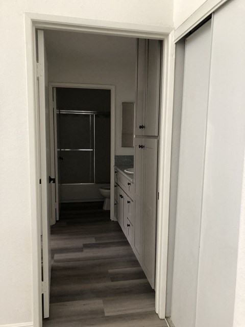 a look down the hallway to the bathroom from the living room