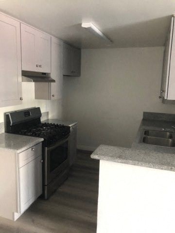 a kitchen with a stove and a sink