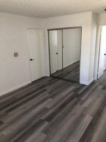 a room with a wood floor and mirrors