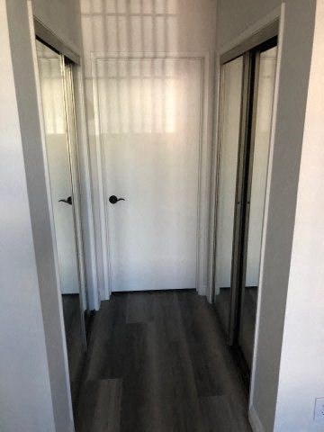 a hallway with two doors and a window