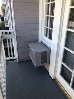 a small air conditioning unit on the side of a house