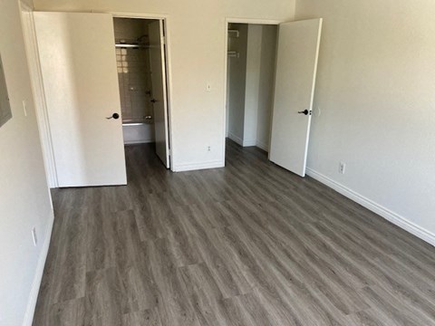 a living room with wood flooring and a bathroom