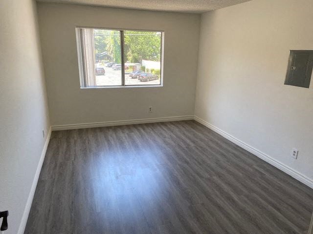 an empty room with a window and wooden floors
