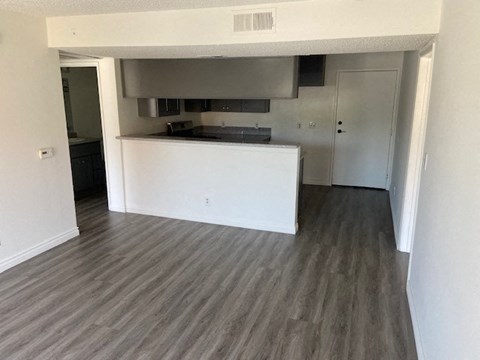 an empty living room and kitchen in a house