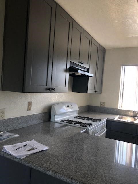 a kitchen with a stove and a counter top