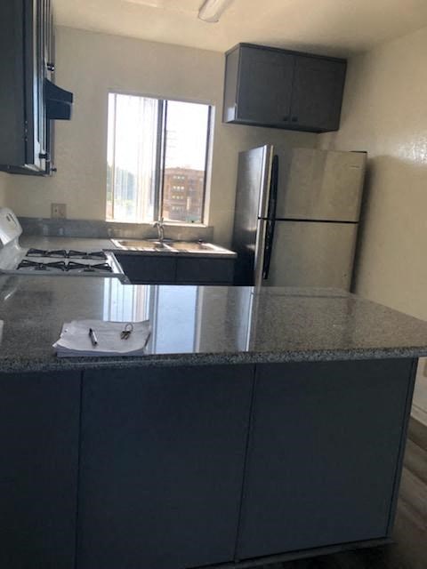 a kitchen with a counter top and a refrigerator