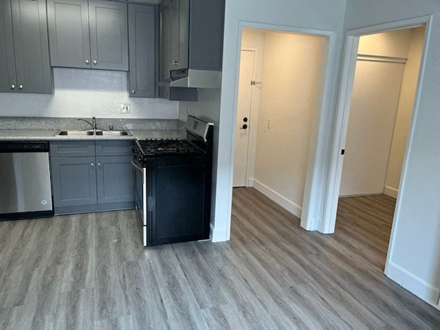 an empty kitchen with a stove and a sink
