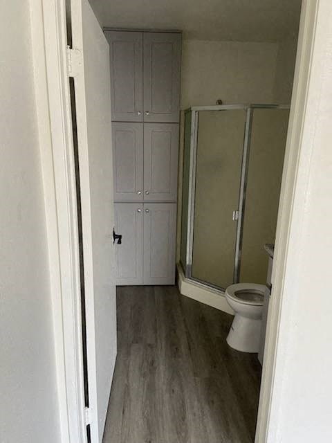 a bathroom with a toilet and a shower