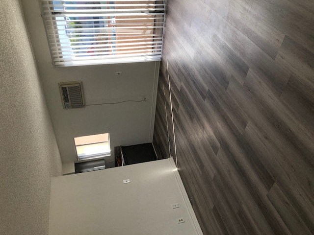 a small room with a refrigerator and a window