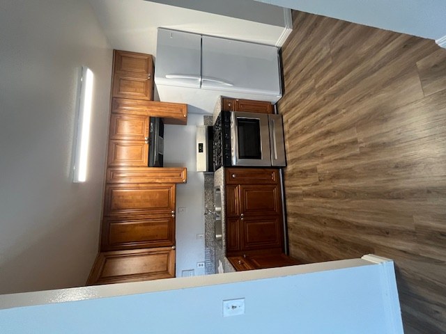 A kitchen with a microwave and a refrigerator.