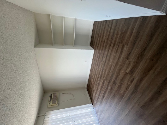 A room with a wooden wall and a white ceiling.