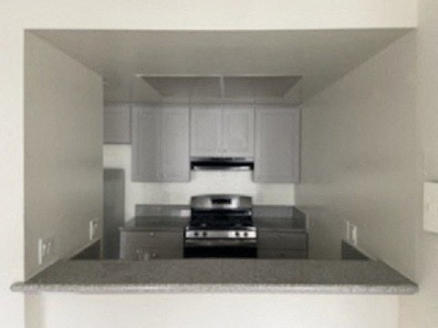 a kitchen with a counter top and a stove