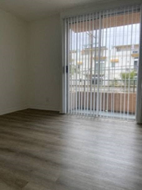a living room with a wood floor and a sliding glass door