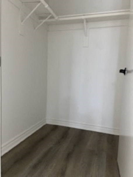 a empty room with white walls and a wooden floor