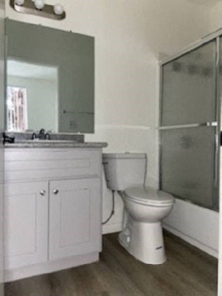 a bathroom with a toilet and a sink and a shower
