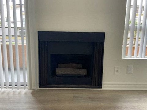 a fireplace in a living room next to a window
