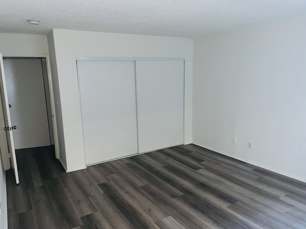 A room with a grey floor and white walls.