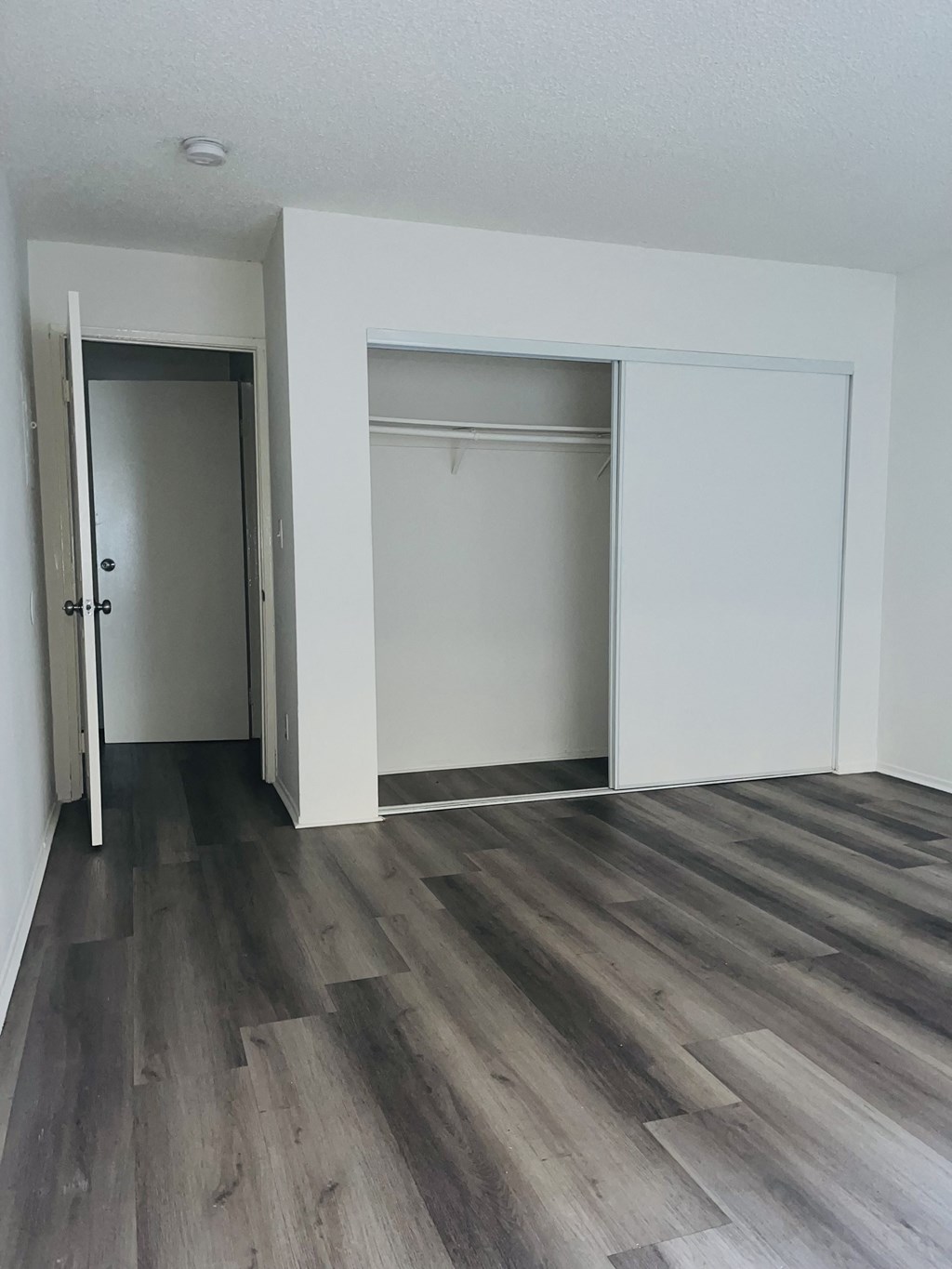 A room with a grey floor and white walls.