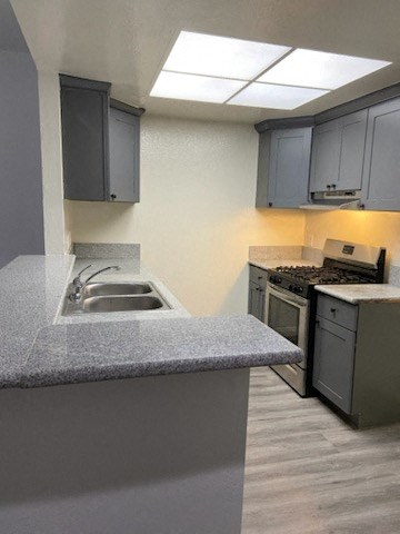 a kitchen with a sink and a stove and a sink