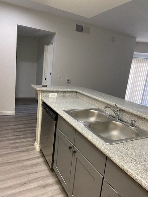 an empty kitchen with a sink and a window