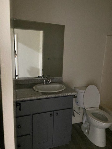 a bathroom with a sink toilet and a mirror