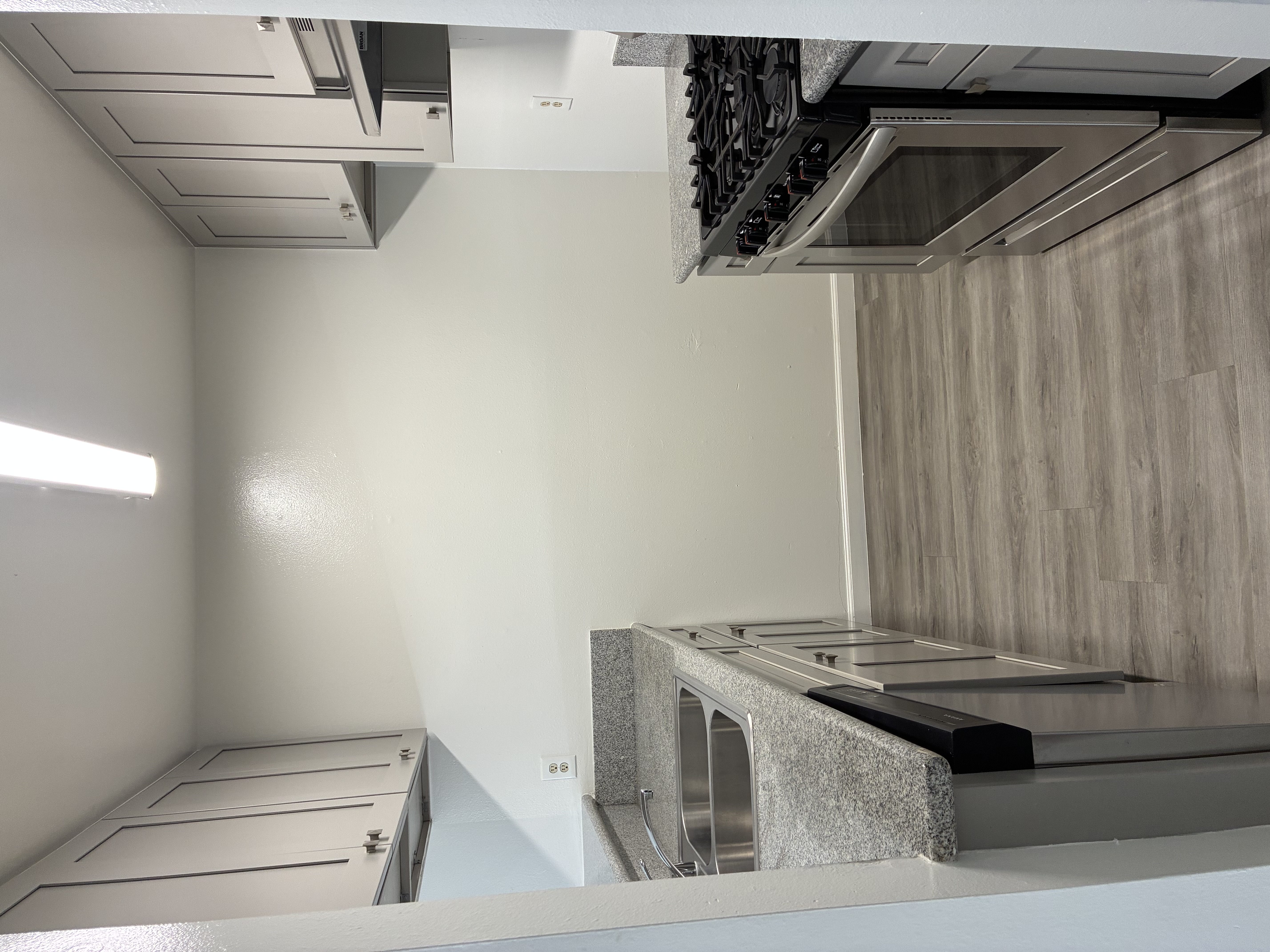 A kitchen with a stainless steel counter and cabinets.