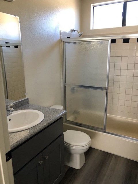a bathroom with a sink toilet and shower
