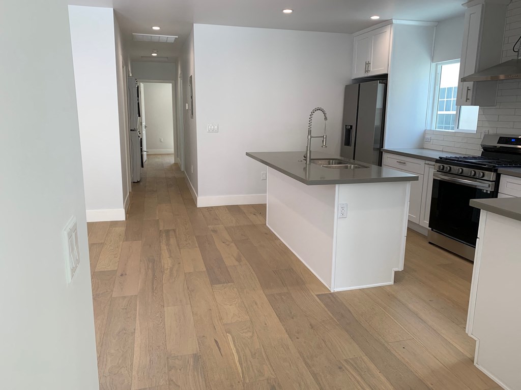 a renovated kitchen with a large island in the middle of it