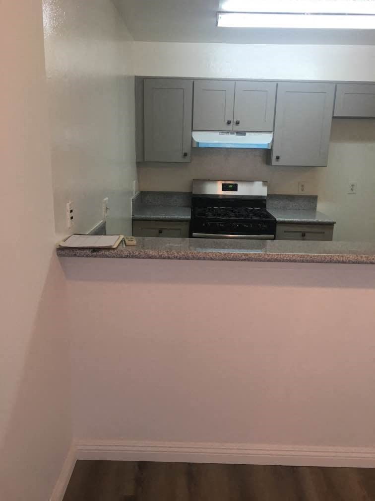 a kitchen with white cabinets and a counter top