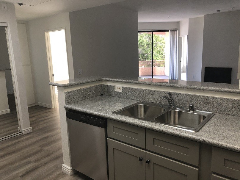 an empty kitchen with a sink and a window