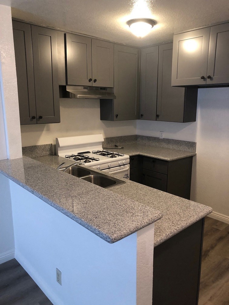 a kitchen with granite counter tops and a stove and