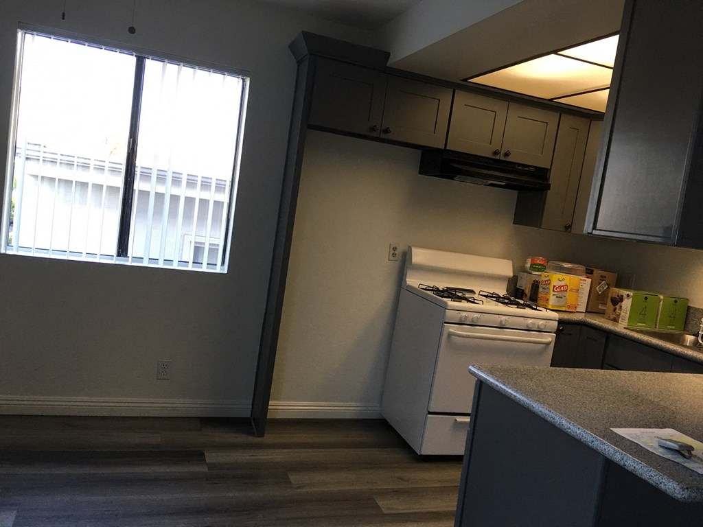 a kitchen with a stove and a window