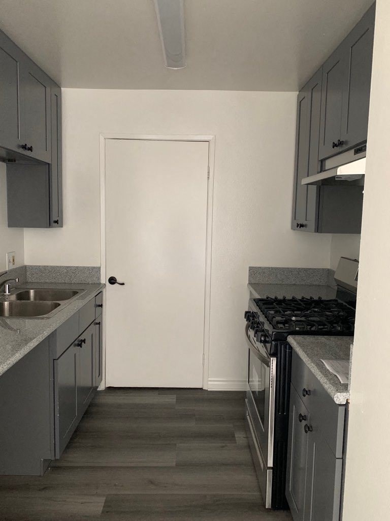 a small kitchen with a stove and a sink