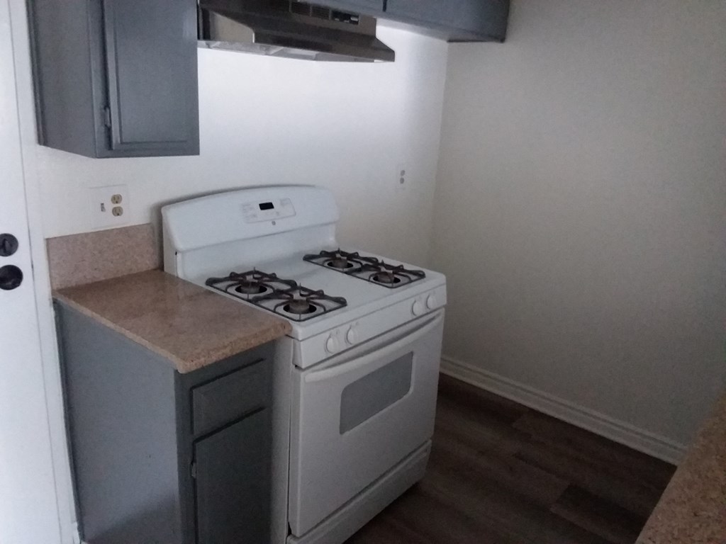 the kitchen has a stove and a microwave in it