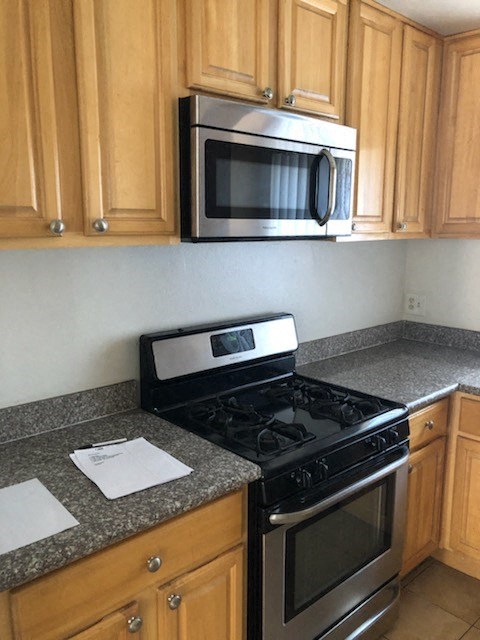 a kitchen with a stove and a microwave