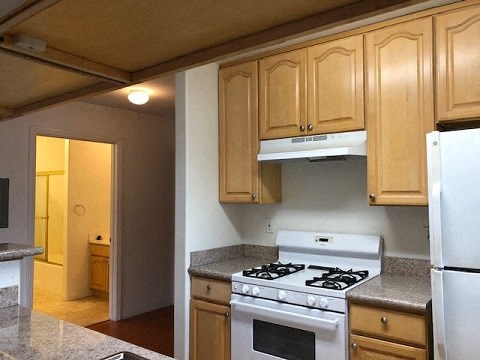 a kitchen with a stove and a refrigerator