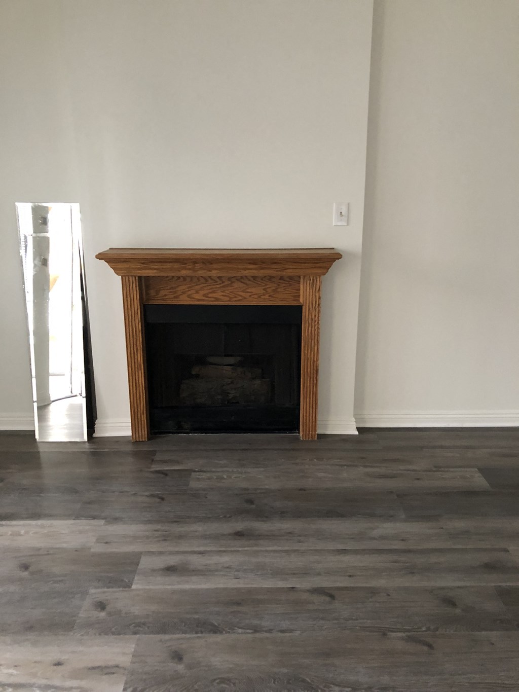 a living room with a fireplace and wooden floors