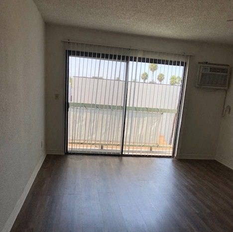 an empty living room with a sliding glass door