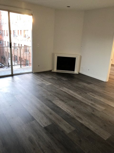 a living room with wood flooring and a fireplace