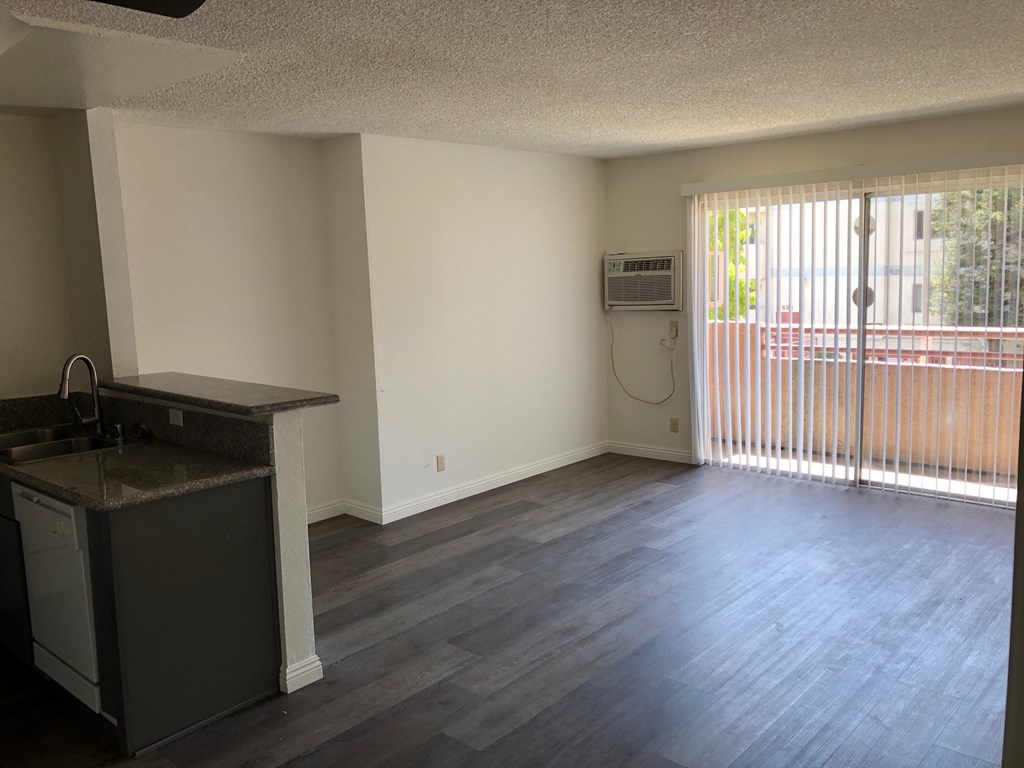 an empty kitchen and living room in an empty apartment
